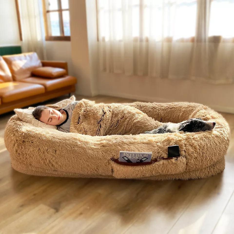 "Plush oversized lounger for pets and owners, featuring gray memory foam and plush bolsters for ultimate comfort and style."