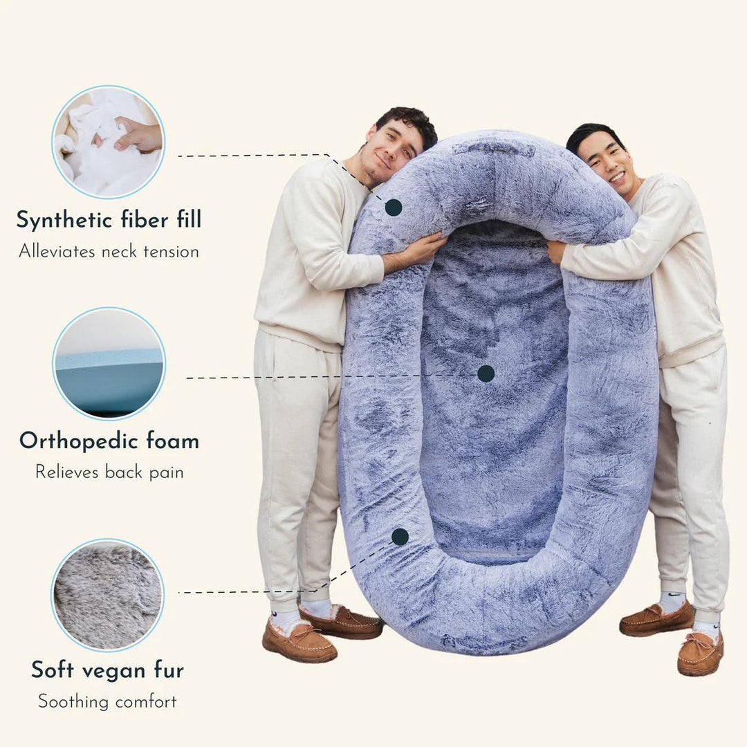 "Plush oversized lounger for pets and owners, featuring gray memory foam and plush bolsters for ultimate comfort and style."