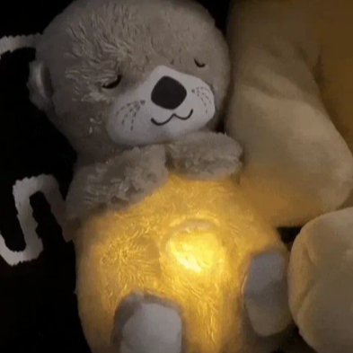 Plush teddy for kids with glowing nightlight, soothing heartbeat, realistic breathing; provides comfort and relaxation.