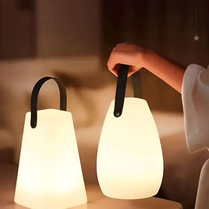 Portable waterproof cordless lamp with remote control, sleek modern design, suitable for indoor and outdoor lighting.