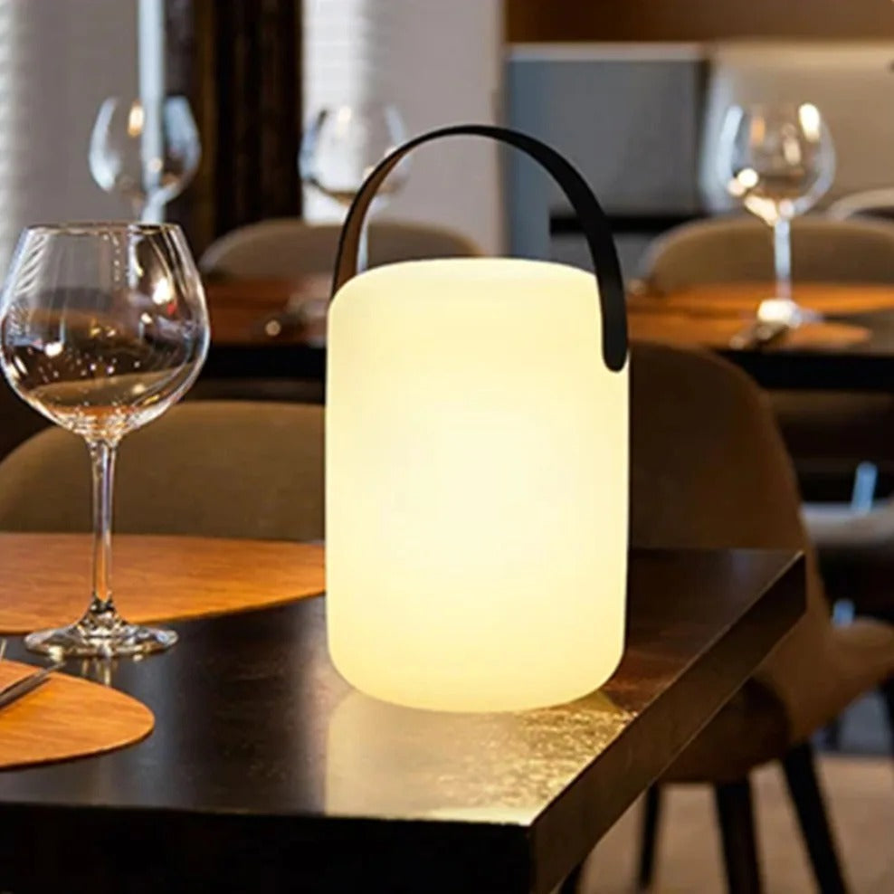 Portable waterproof cordless lamp with remote control, sleek modern design, suitable for indoor and outdoor lighting.