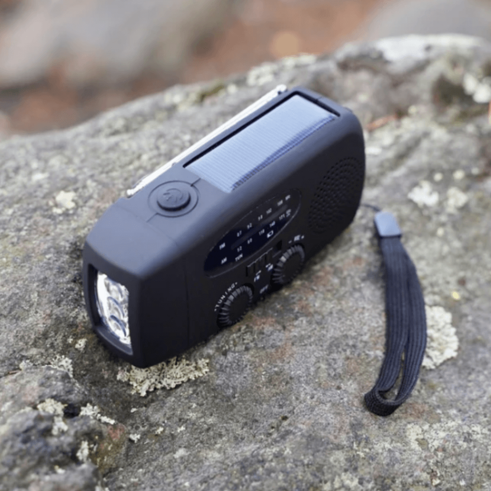 "Portable wind-up radio with LED flashlight and power bank, compact design, suitable for AM/FM/weather alerts and emergencies