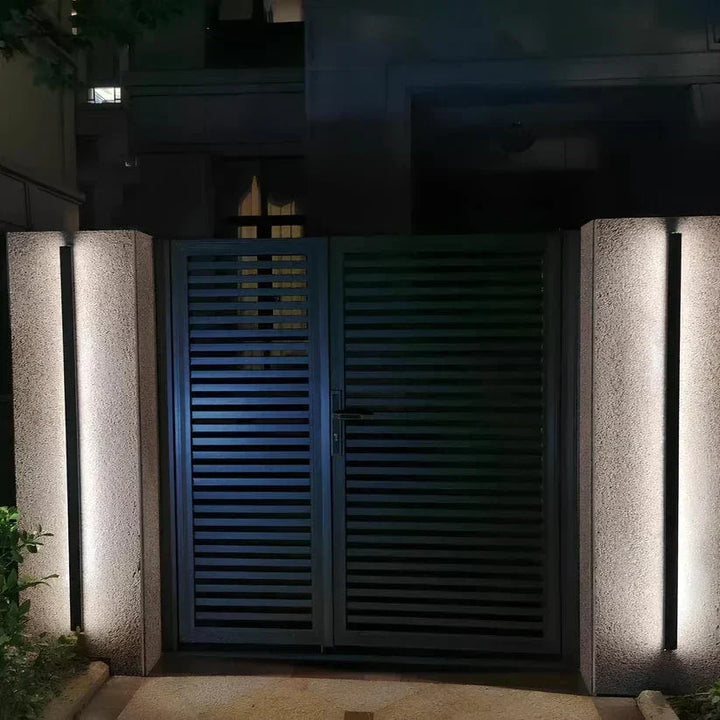 Sleek aluminium outdoor wall sconce with backlit design, ideal for modern patios; corrosion-resistant and stylish.