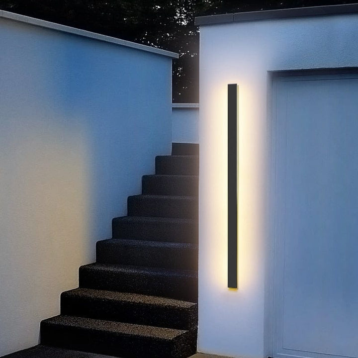 Sleek aluminium outdoor wall sconce with backlit design, ideal for modern patios; corrosion-resistant and stylish.