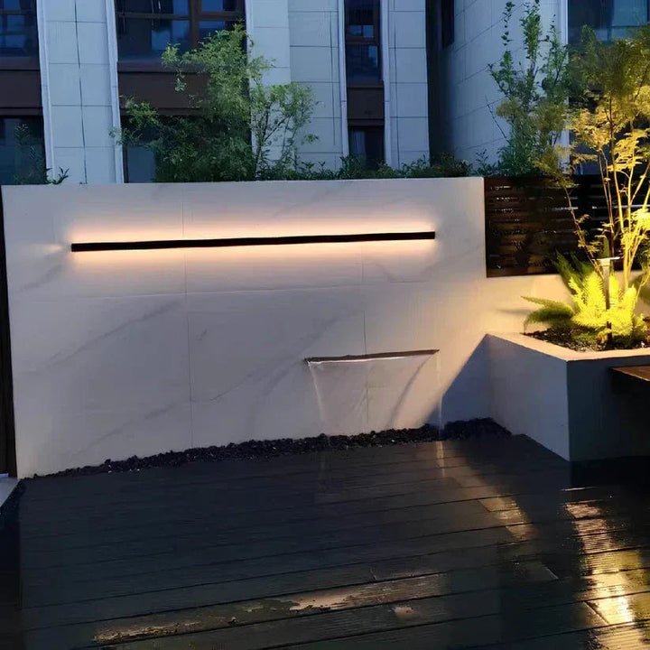 Sleek aluminium outdoor wall sconce with backlit design, ideal for modern patios; corrosion-resistant and stylish.