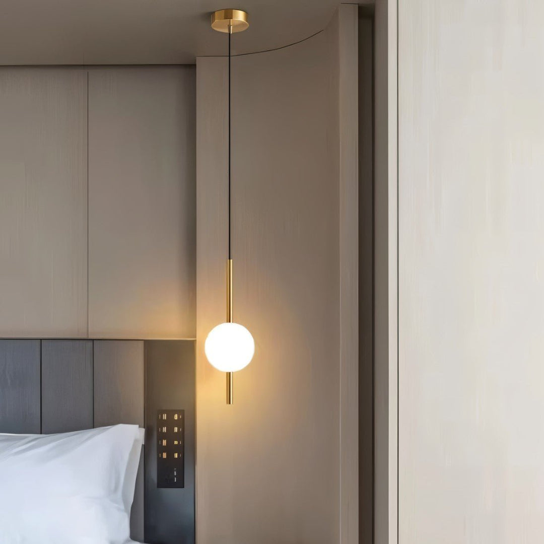 "Sleek glass ball Nordic pendant light with metal frame, LED bulb; available in black or brass, perfect for modern decor."