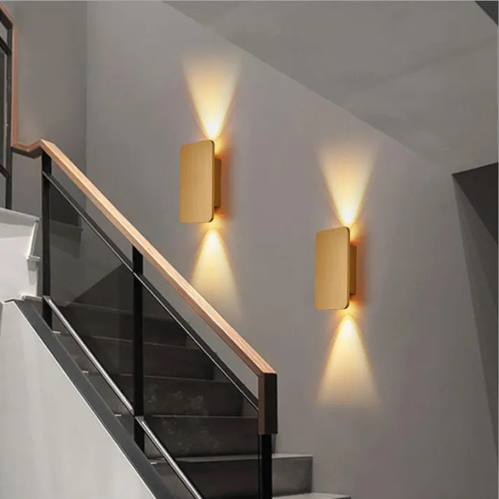 "Sleek indoor LED wall lamp with a modern rectangular design, featuring smooth finishes and warm illumination for elegant dec
