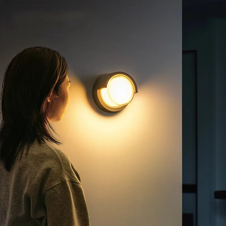 Sleek outdoor wall lamp with motion sensor and LED light, featuring IP65 waterproof rating and minimalist geometric design.