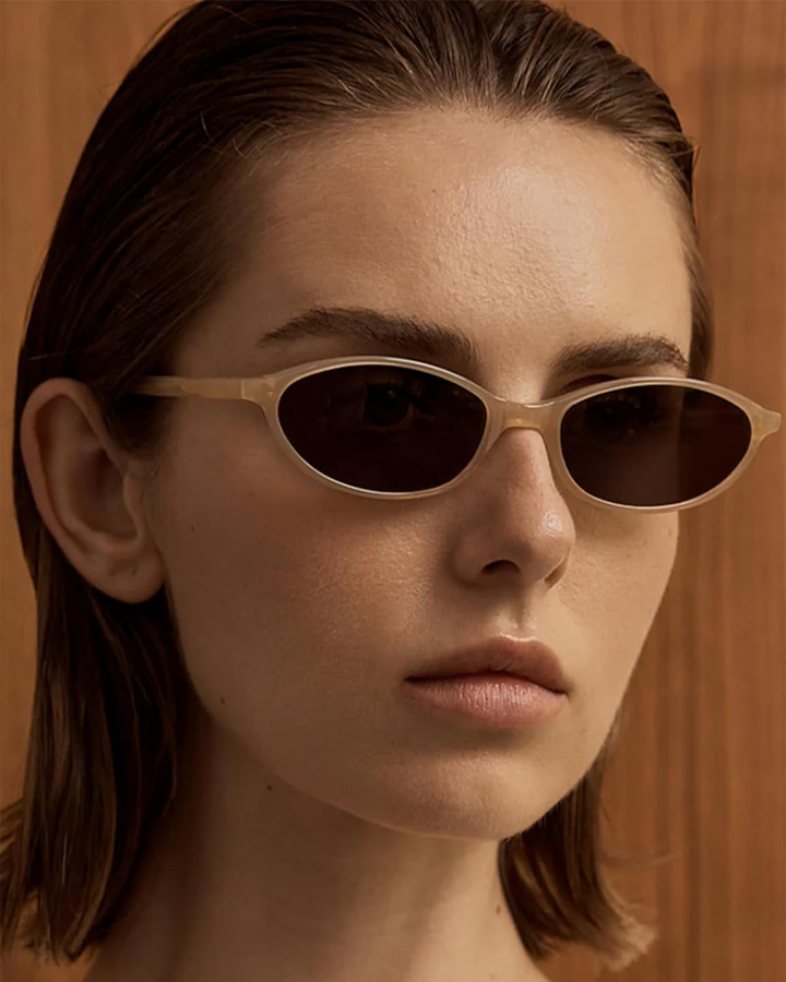 Sleek oval sunglasses for women, perfect retro 90s fashion accessory.