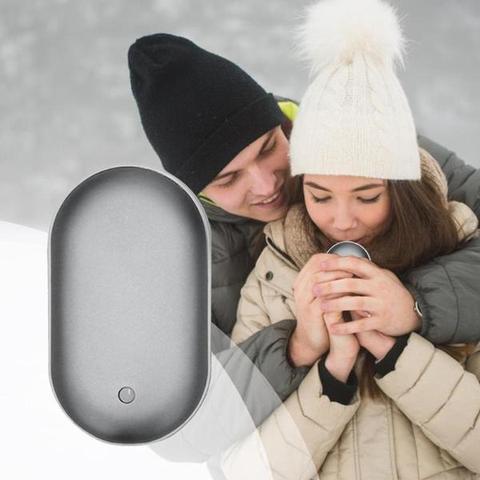 "Sleek silver portable USB hand warmer and powerbank, compact size, double-sided heating, ideal for chilly outdoor use."