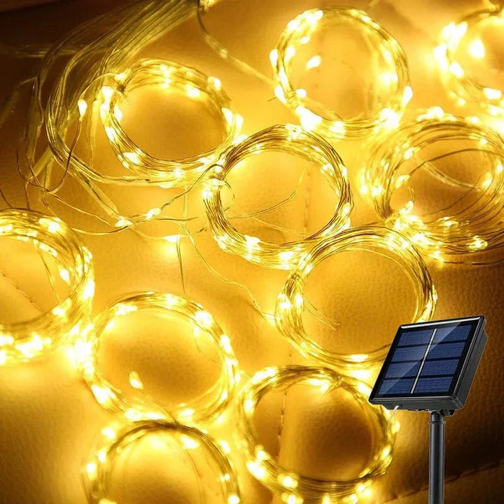 "Solar LED curtain light with copper wire, ideal for events, featuring warm white LEDs and solar power, outdoor use."