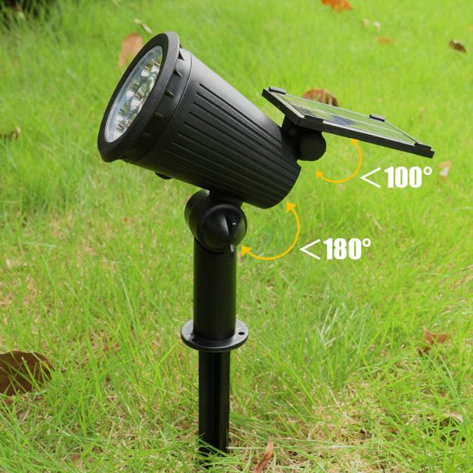 "Solar-powered LED garden spotlight with 9 color options, illuminating a pathway; eco-friendly outdoor lighting solution."
