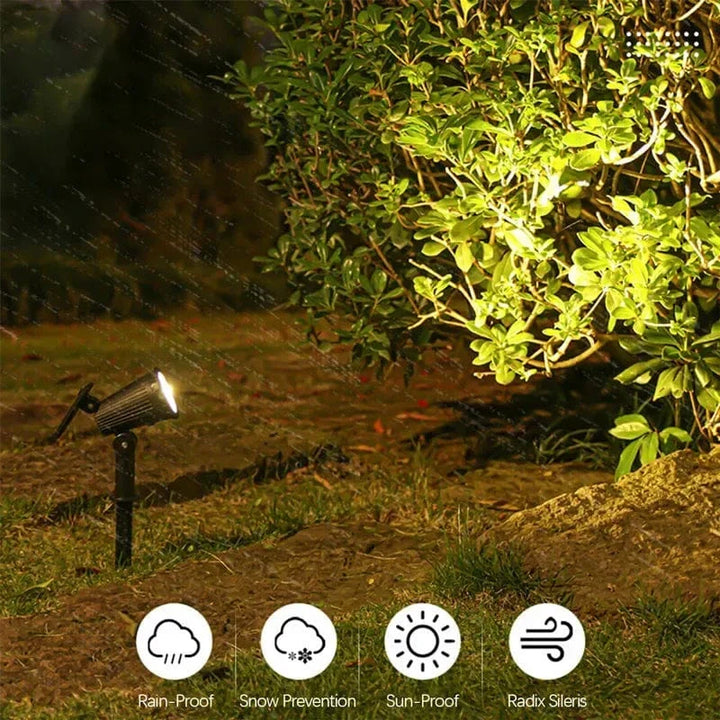 "Solar-powered LED garden spotlight with 9 color options, illuminating a pathway; eco-friendly outdoor lighting solution."