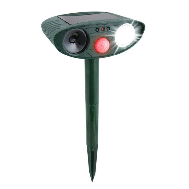 Solar-powered ultrasonic deer repeller with green casing, motion sensor, solar panel, ideal for outdoor garden protection.