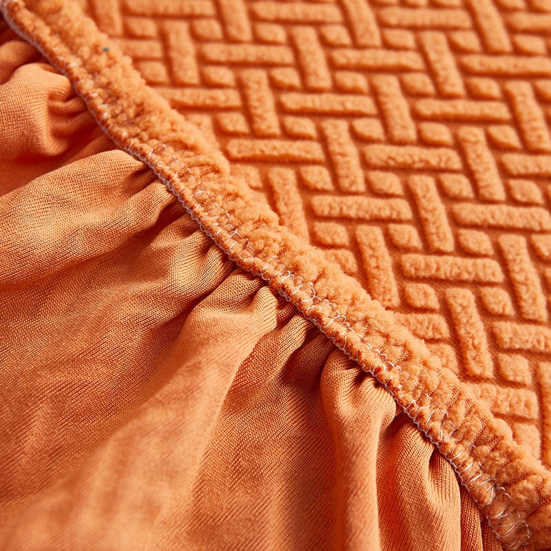 Stretchable sectional sofa cover in vibrant tangerine, snug fit, durable fabric, ideal for home decor and furniture protectio