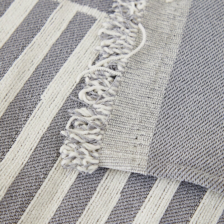 "Striped sofa throw cover, durable stretchable fabric, minimalist pattern, elevates living space, protects against spills."