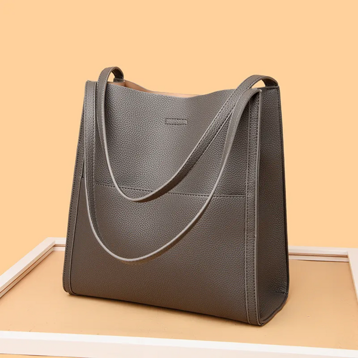 Elegant brown leather shoulder bag, versatile for work or travel. A large capacity tote for the modern woman.