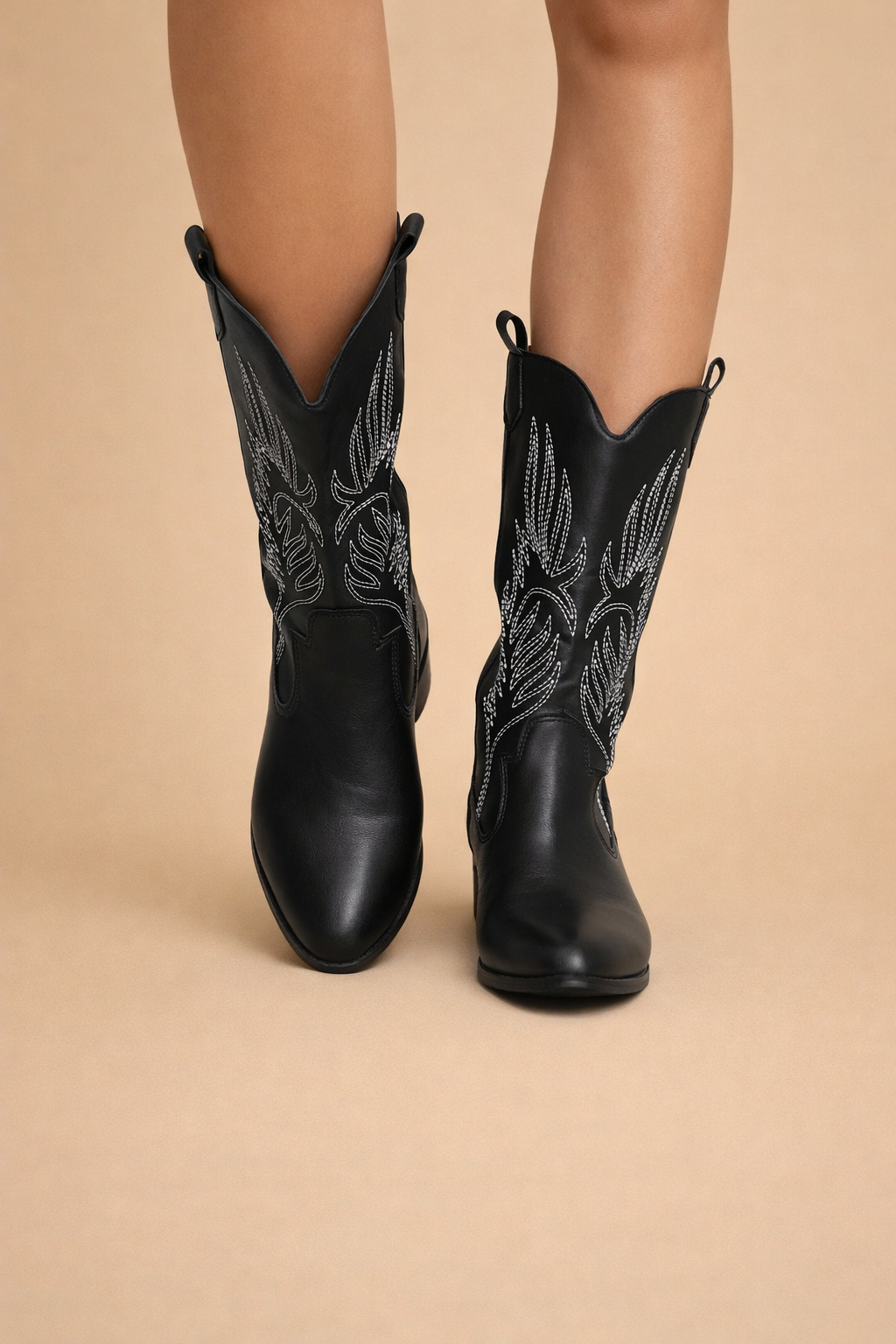 Chic black women's cowboy boots. Stylish pointed toe & comfortable low heel for modern western fashion footwear.