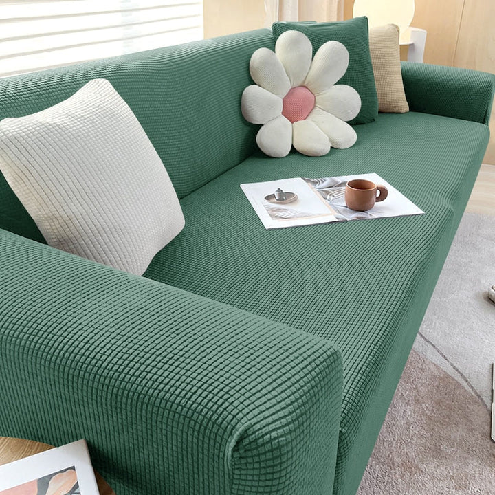 "Textured stretch sofa cover in beige, snug fit for sofas, non-slip, adds elegance, protects against spills and wear."