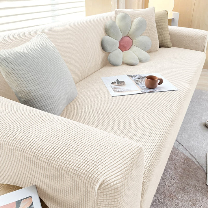 "Textured stretch sofa cover in beige, snug fit for sofas, non-slip, adds elegance, protects against spills and wear."
