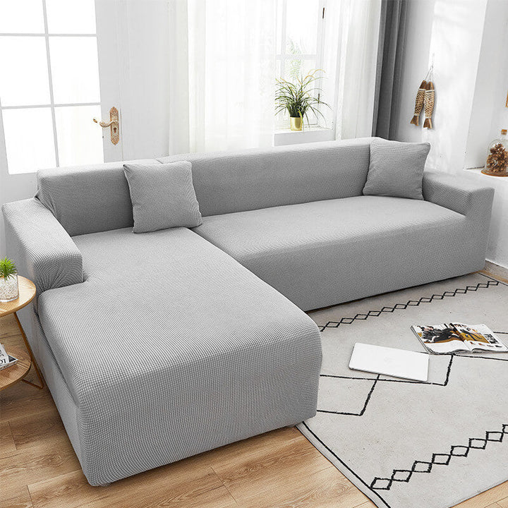 "Textured stretch sofa cover in beige, snug fit for sofas, non-slip, adds elegance, protects against spills and wear."