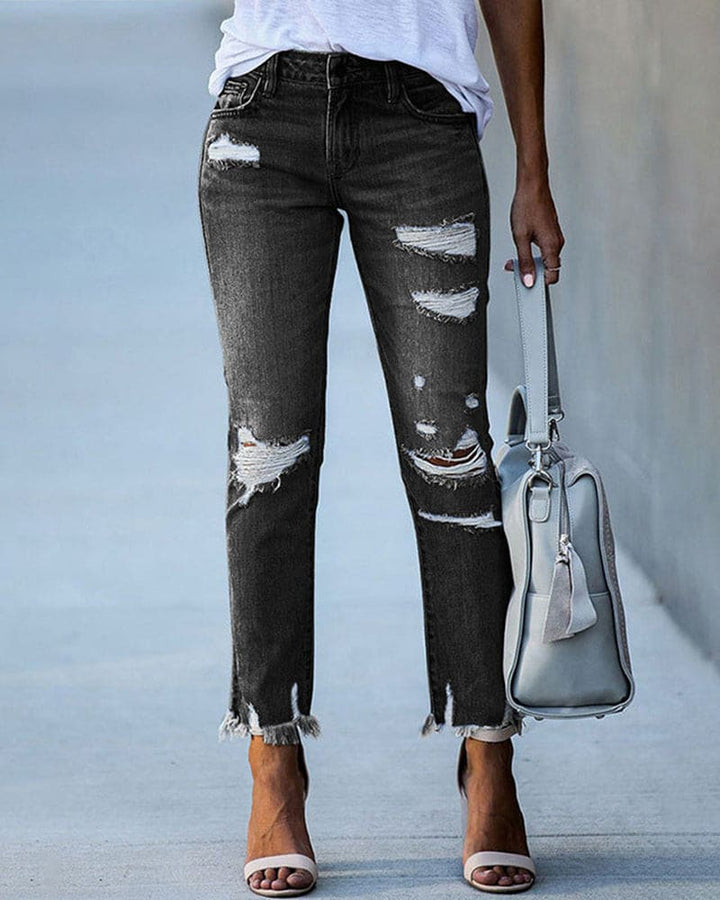 Fashionable blue ripped denim jeans for women, showcasing a trendy casual style with distressed accents.