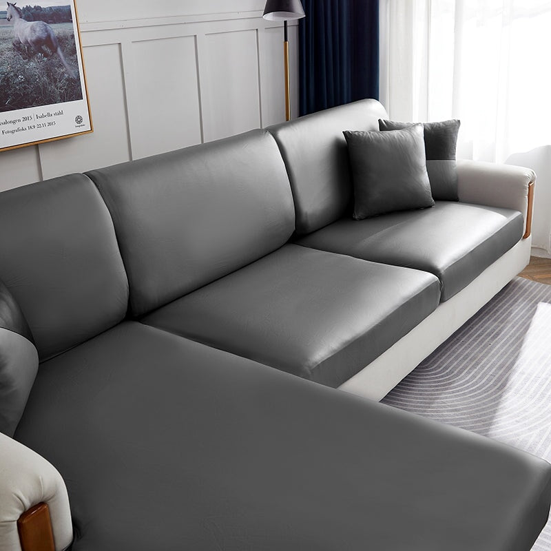 "Waterproof sectional sofa cover in smoke grey, sleek design for leather protection, durable stretchable fabric, snug fit."