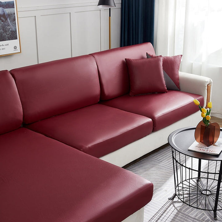 "Waterproof sectional sofa cover in smoke grey, sleek design for leather protection, durable stretchable fabric, snug fit."