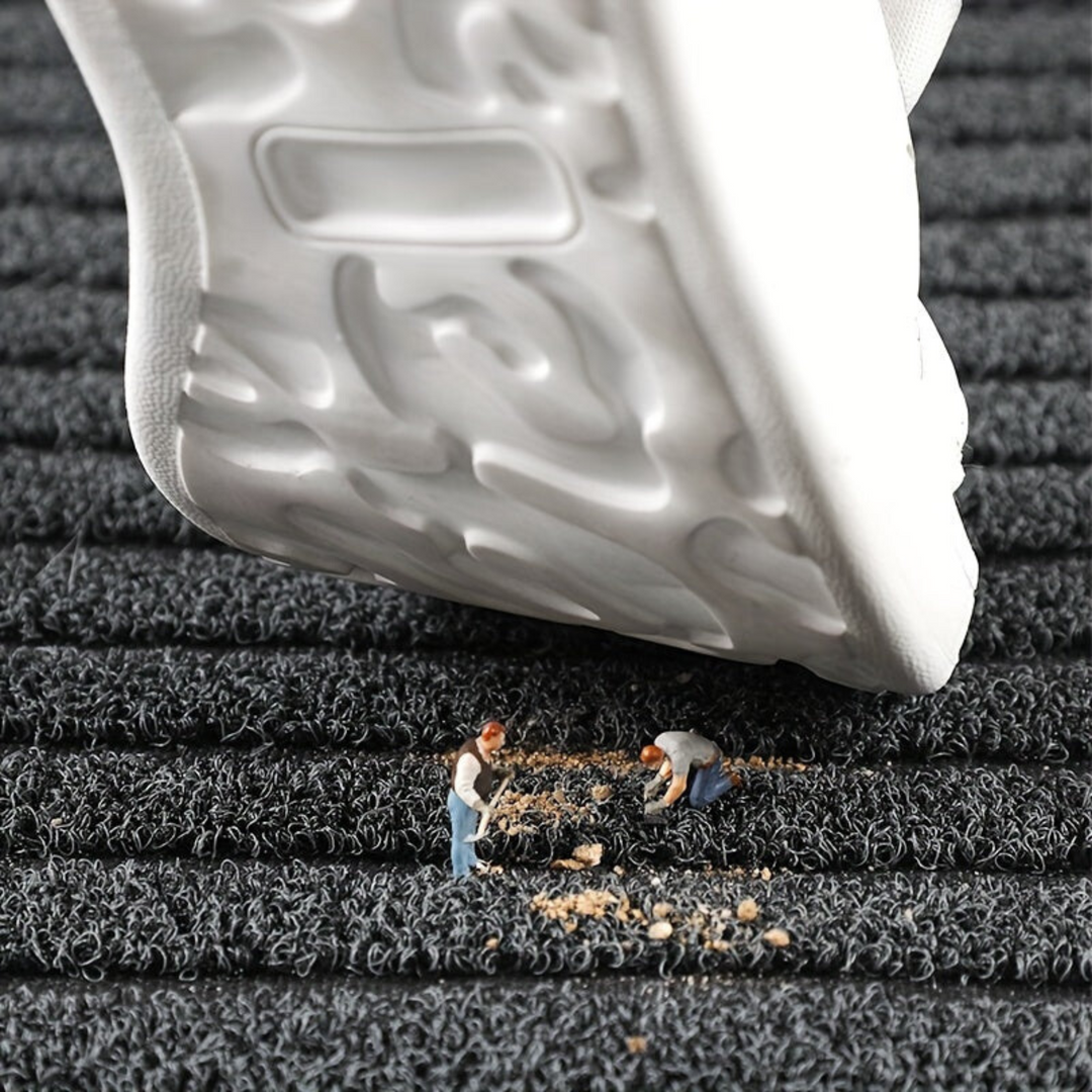 "Weatherproof non-slip outdoor rug with black and grey stripes, ideal for entrances and hallways, enhances safety and style."