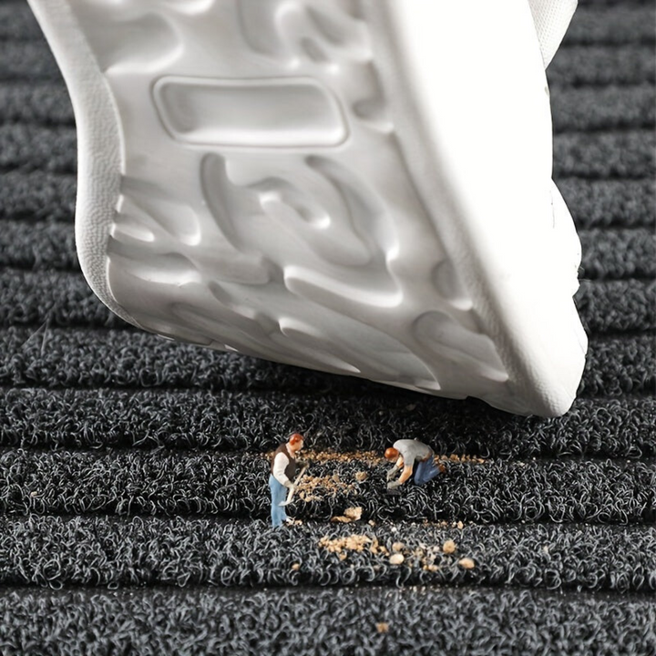 "Weatherproof non-slip outdoor rug with black and grey stripes, ideal for entrances and hallways, enhances safety and style."