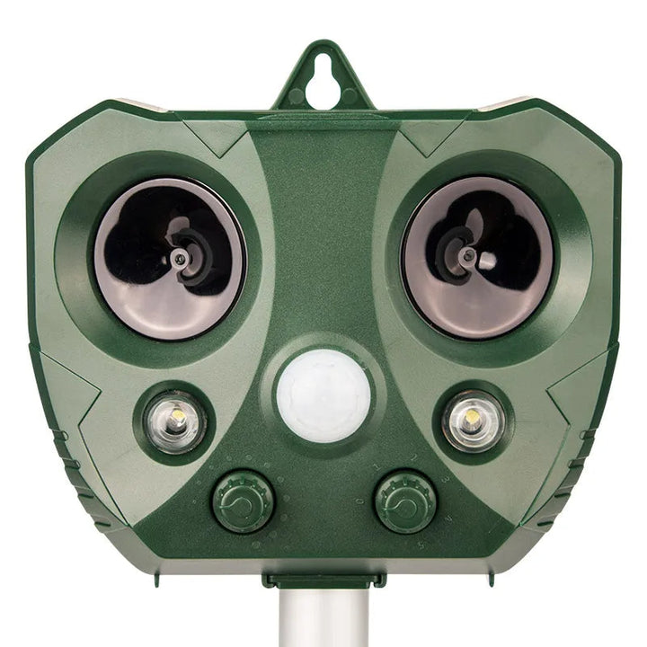 "Weatherproof solar ultrasonic animal repeller in garden, motion-activated to deter pests like cats and rodents."