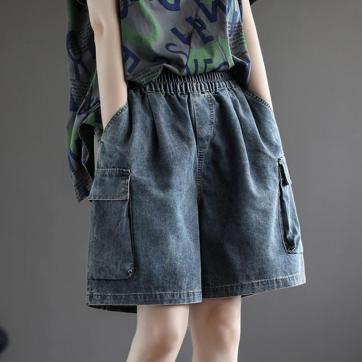 Women's baggy cargo jorts in blue denim, featuring a relaxed wide leg and multiple utility pockets for casual streetwear.