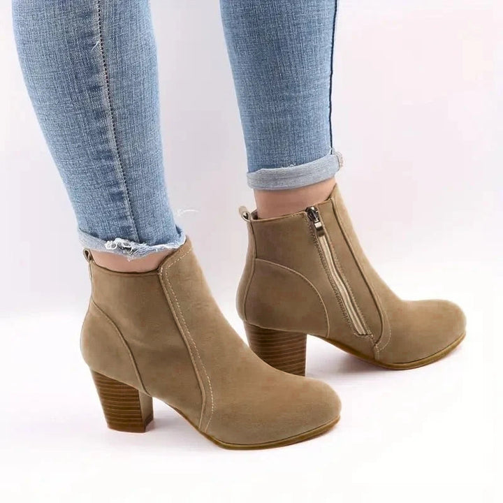 Women's black block heel ankle boots with side zip closure, perfect for fall and winter fashion.