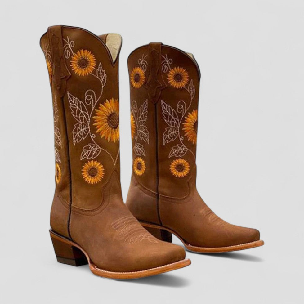 Fashionable women's black cowgirl boots with detailed floral embroidery and a practical low block heel.