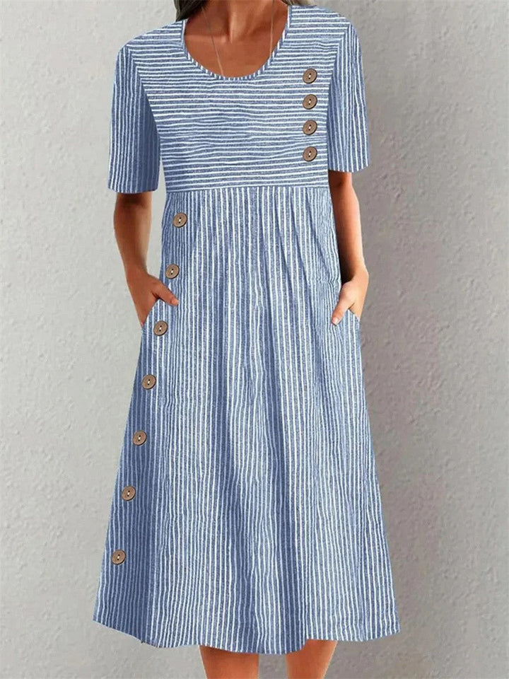 Women's blue A-line dress with button detail, elegant & flattering for daily wear or summer casual.