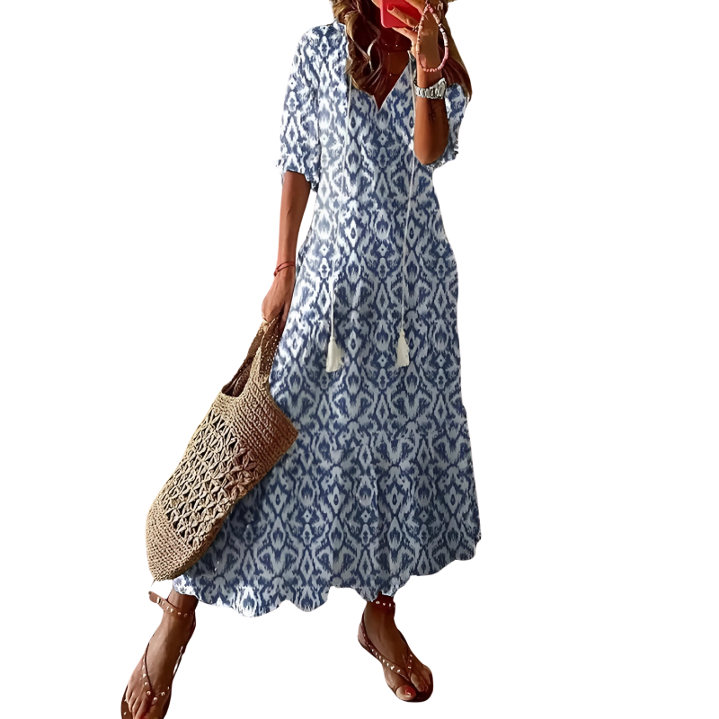 Polyester women's maxi dress with a bohemian floral print. Flowy long silhouette for elegant summer fashion.