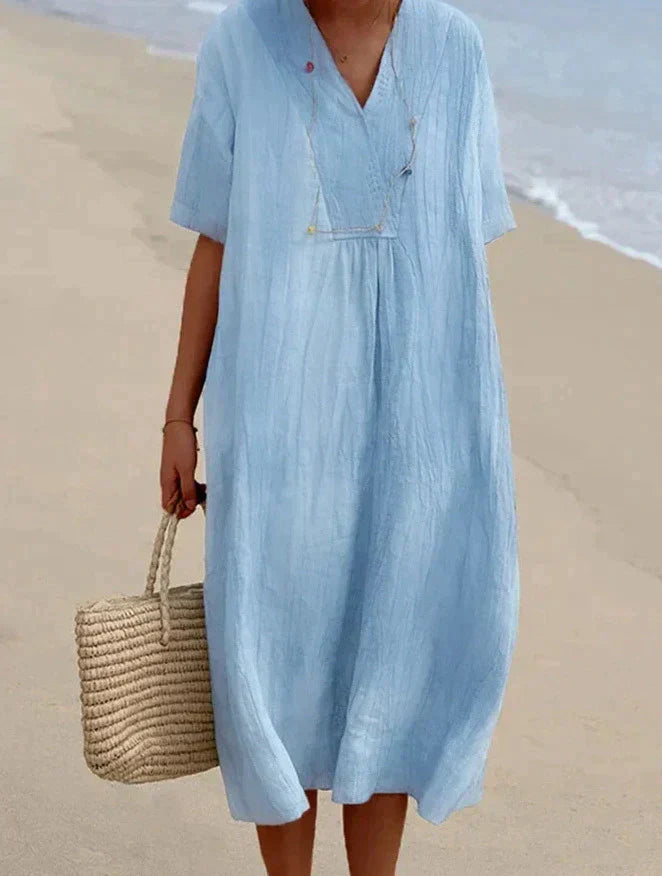 Women's breezy cotton linen summer midi dress in a vibrant color, perfect for casual wear and vacations.