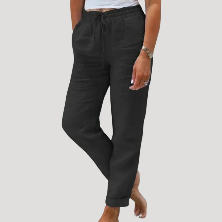 Women's tapered leg linen pants, relaxed fit with drawstring, offering a chic & comfortable summer look.
