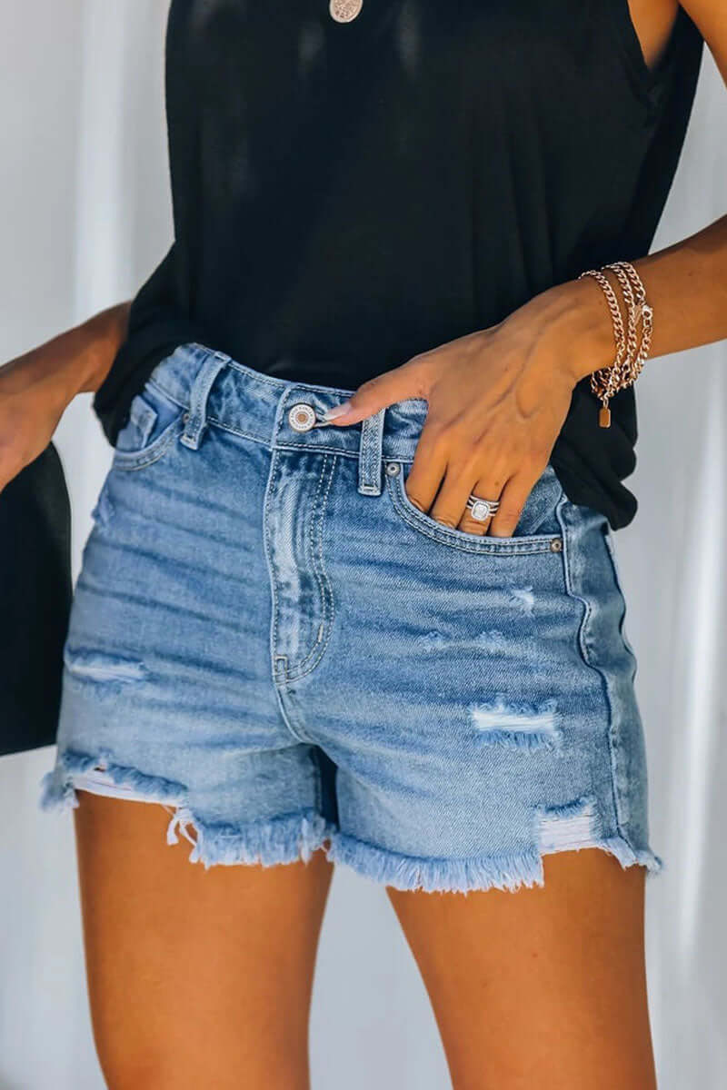 Women's chic blue ripped denim shorts, perfect for a casual summer style. Trendy distressed women's shorts.