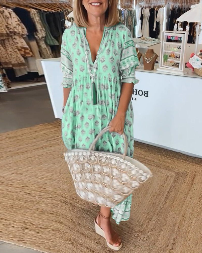 Flowy women's maxi dress with vibrant floral print and V-neck, perfect for spring/summer.