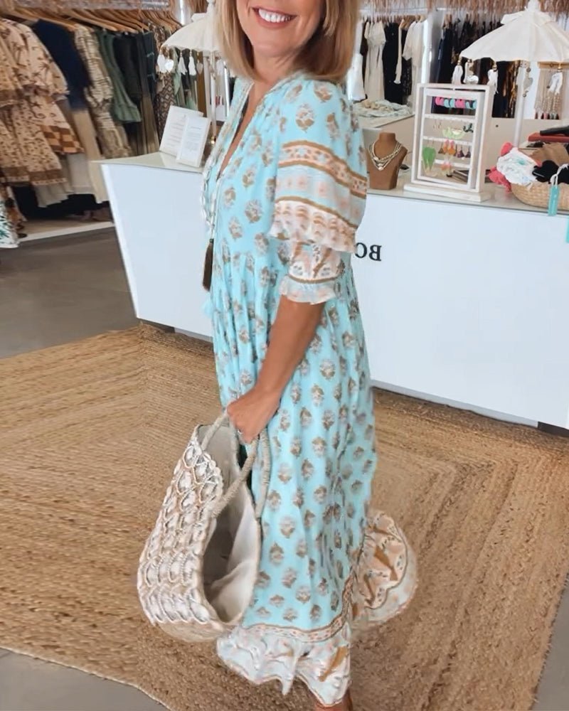 Women's V-neck maxi dress featuring a beautiful floral pattern and elegant silhouette.