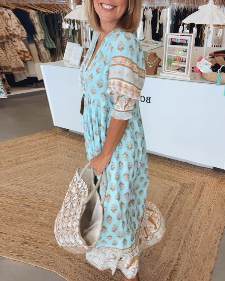 Women's V-neck maxi dress featuring a beautiful floral pattern and elegant silhouette.