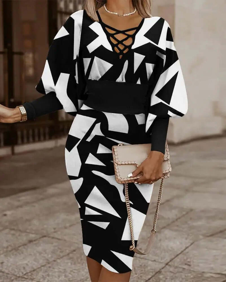 Model wearing women's chic geometric print two-piece summer outfit: batwing top & midi skirt. Casual & fashionable.