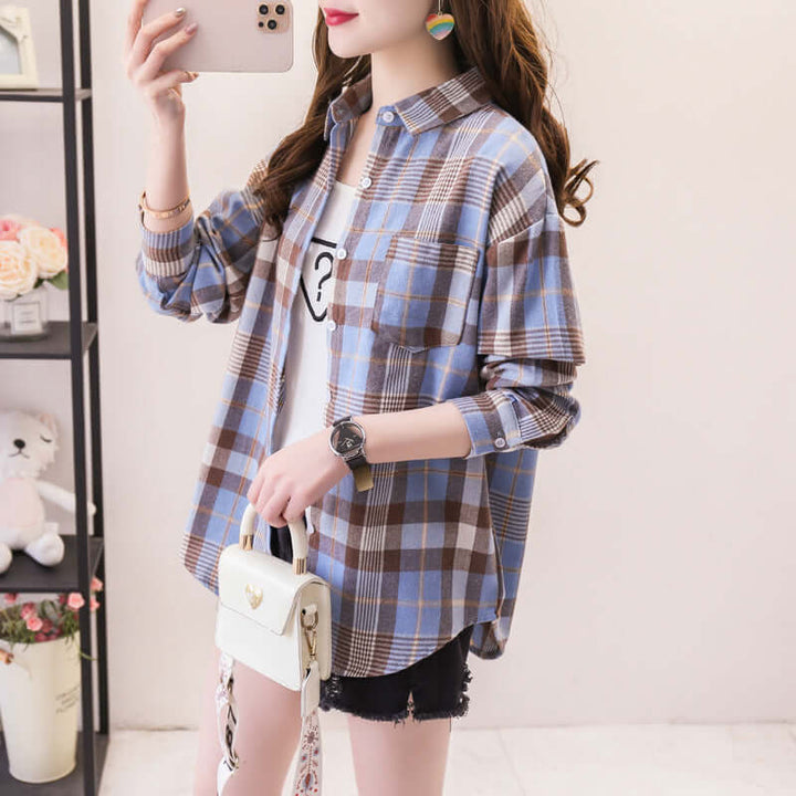 Women's button-down long sleeve shirt featuring a vibrant classic plaid pattern. Ideal casual top for autumn style.