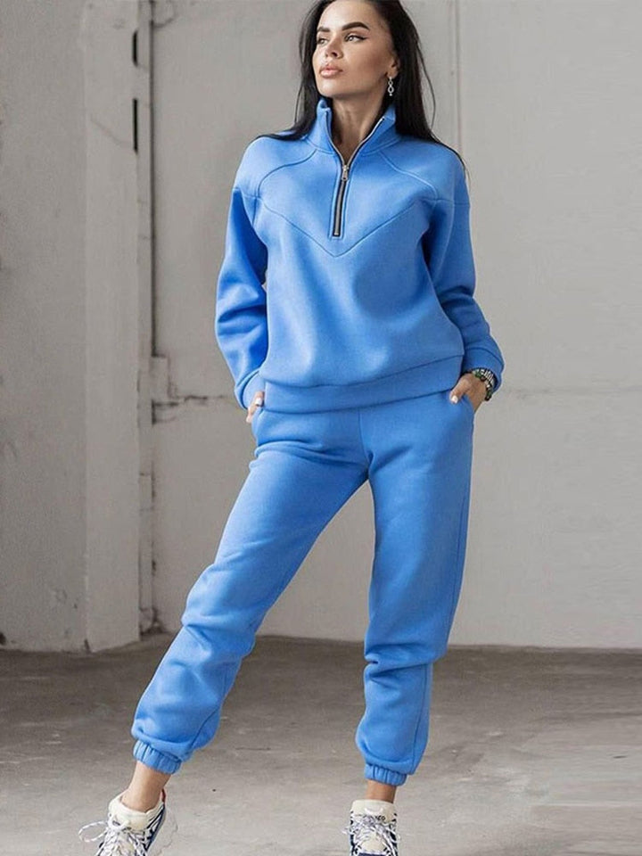 Stylish women's two-piece tracksuit for loungewear, featuring a trendy zip neck top & flattering tapered trousers.
