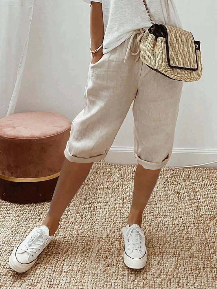 Knee-length women's pants with adjustable drawstring waist, perfect for loungewear & versatile style.