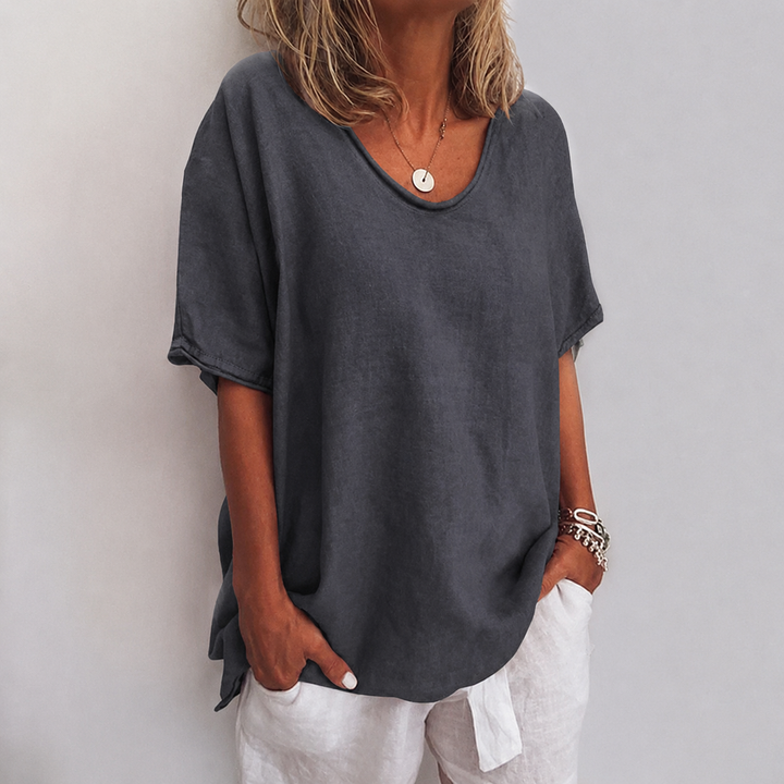 Elegant flowy women's blouse, versatile for work or casual occasions. Effortless style.