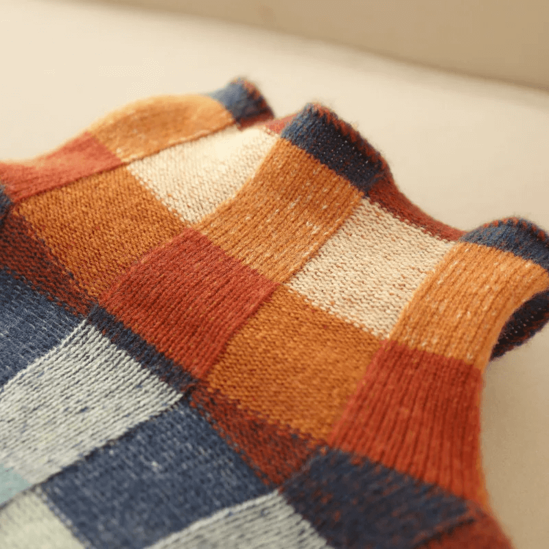 Detailed view of the high collar on a women's cozy knit winter jumper. Warm & stylish pullover sweater design.
