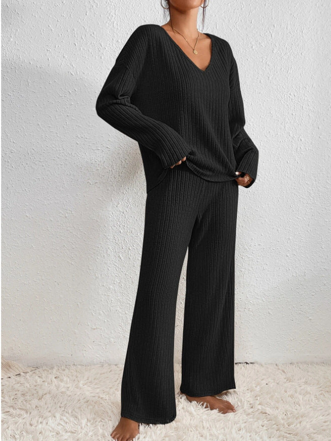 Close-up of the plush knitted texture of a women's cozy 2-piece lounge set. Luxurious feel.