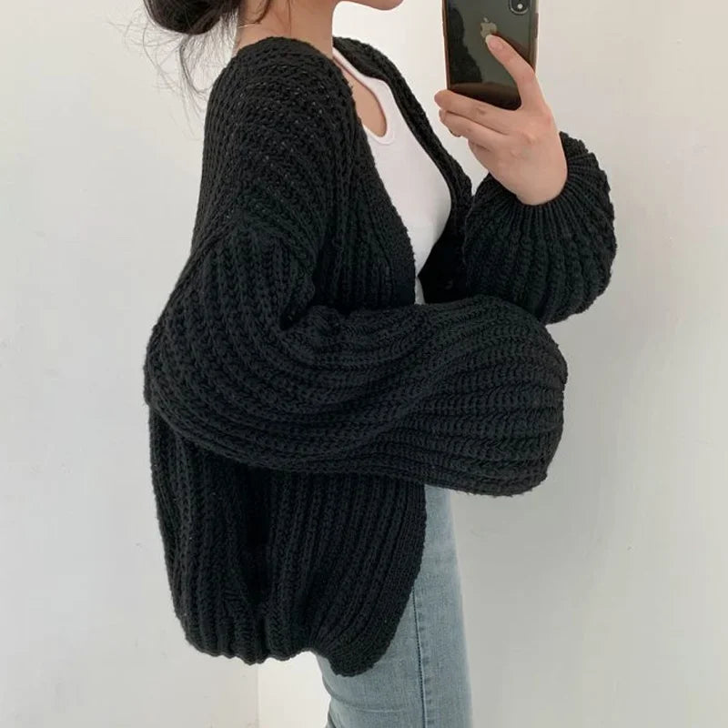 Cozy women's oversized knitwear cardigan with stylish open front & lantern sleeves. Perfect for winter warmth.